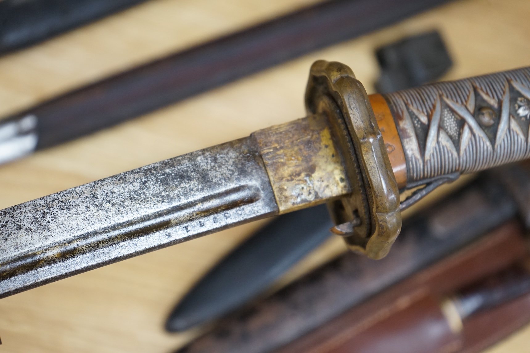 A Japanese World War II NCO‘s sword katana, regulation blade with fuller, stamped 33271, regulation aluminium hilt, brass guard, the spring catch still retains, in an iron scabbard